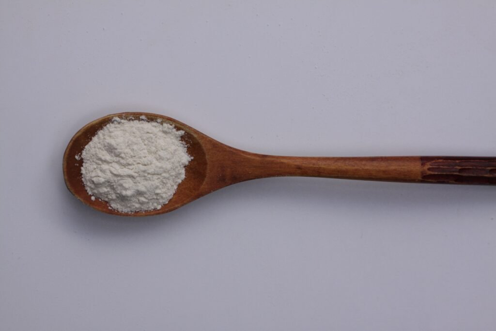 White water-retention system powder in a wooden spoon