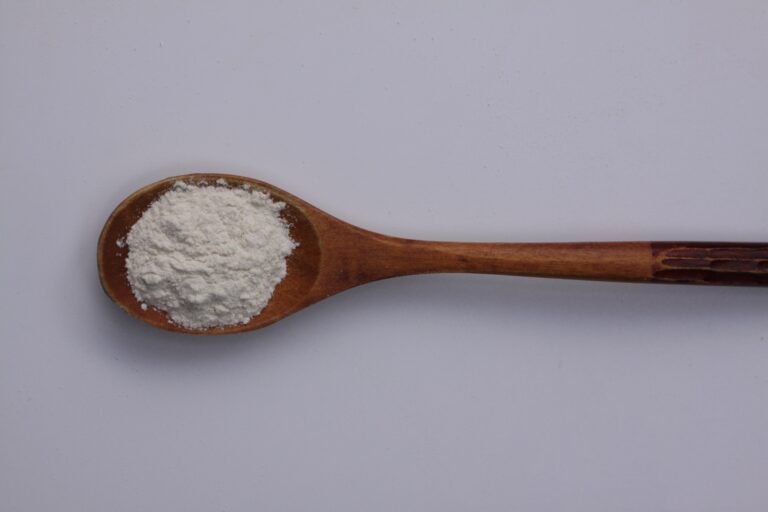 White water-retention system powder in a wooden spoon